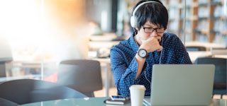 man using computer and thinking