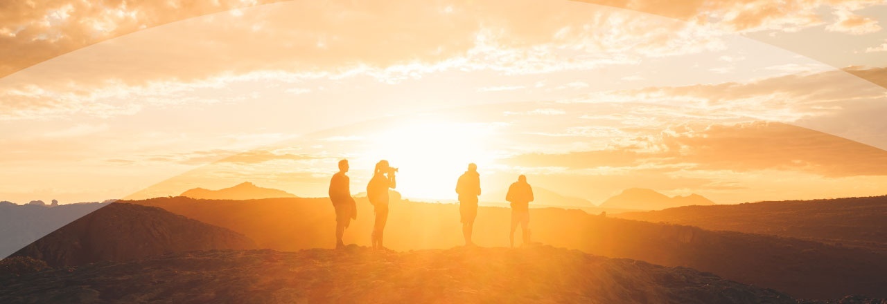 multiple people standing on a hill
