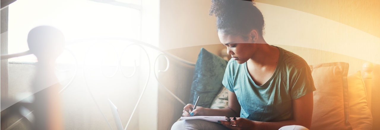 female writing in a notebook
