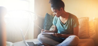 female writing in a notebook