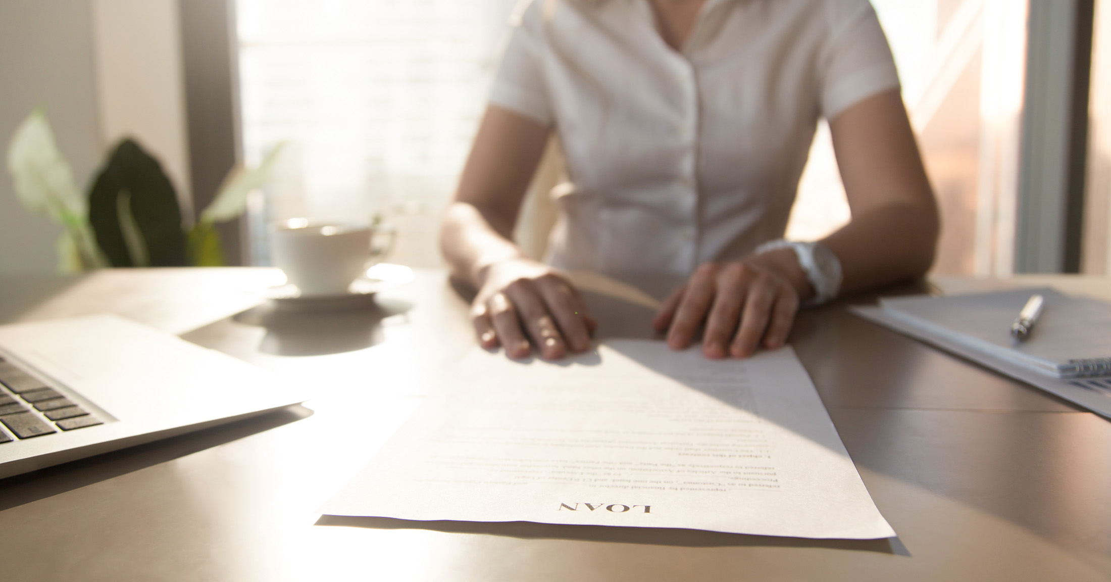 Woman at a desk reviewing documents.