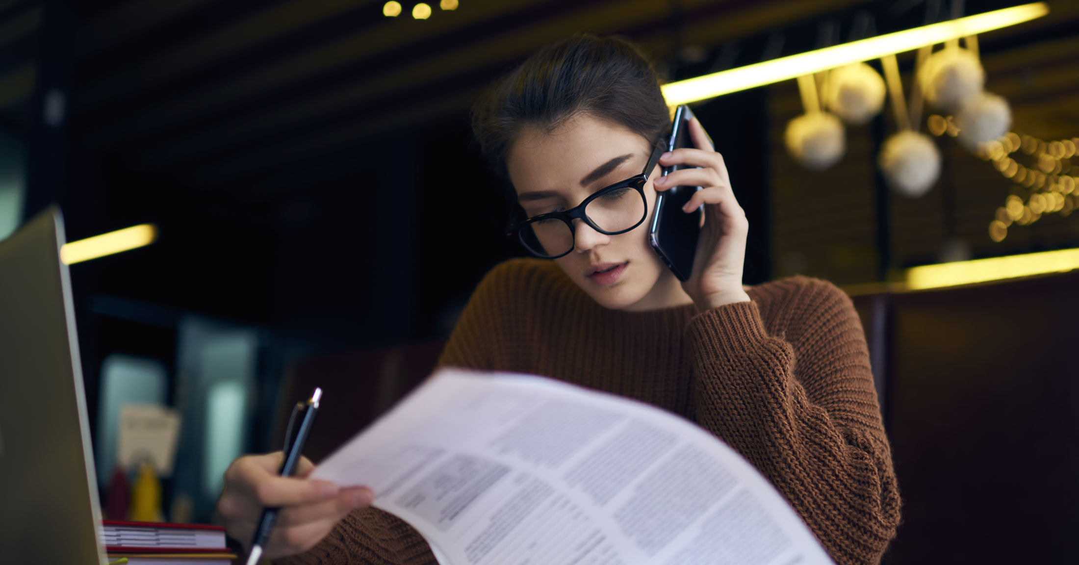 woman on the phone looking over finances